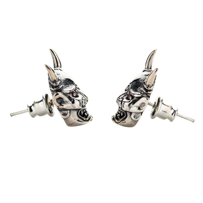 A side shot of the pair of gothic Oni earrings, emphasizing their menacing expression and red eyes.