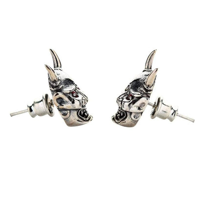 A side shot of the pair of gothic Oni earrings, emphasizing their menacing expression and red eyes.