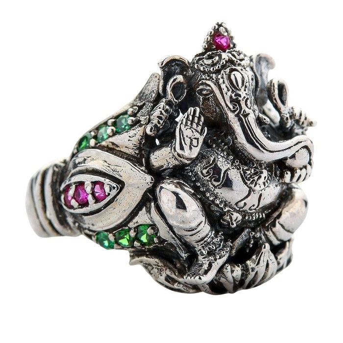 Side view of the handcrafted Ganesh ring, showing the deity on a lotus flower with red and green gems.