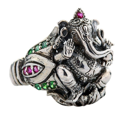 Side view of the handcrafted Ganesh ring, showing the deity on a lotus flower with red and green gems.