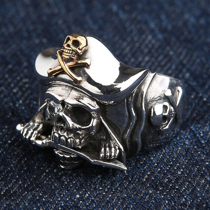 A classic swashbuckler-style skull ring, meticulously handcrafted from solid sterling silver with rich gold accents.