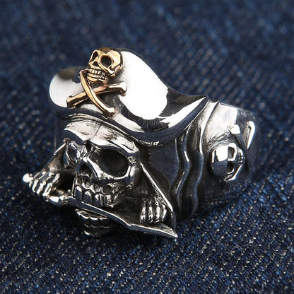 A classic swashbuckler-style skull ring, meticulously handcrafted from solid sterling silver with rich gold accents.