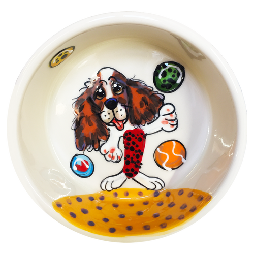 Image of cavalier king charles spaniel playfully ready for fetching tennis balls at the beach hand painted on ceramic pet bowl by faux paw productions artist Debby Carman