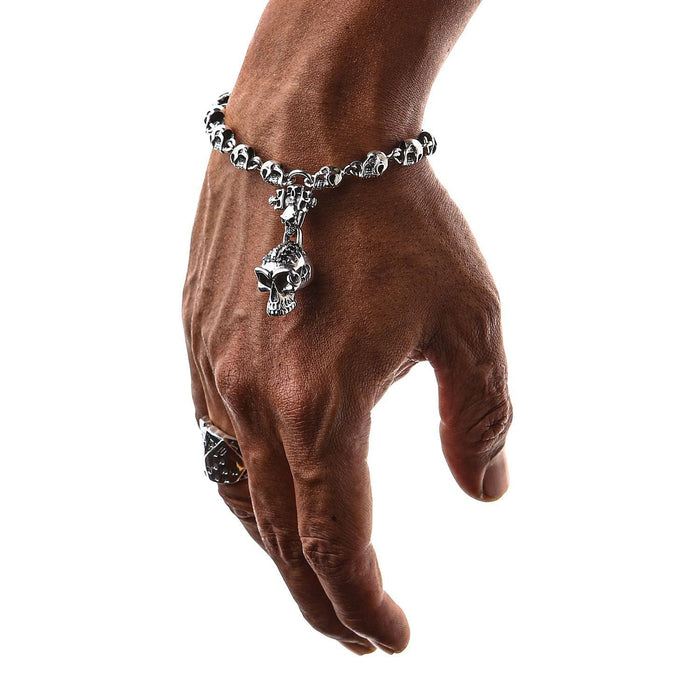 A skull bracelet with a central charm, meticulously detailed with sparkling black CZ stones.