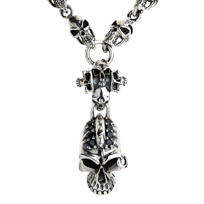 A gothic skull chain bracelet featuring a menacing central skull encrusted with black stones and a classic T-bar clasp.