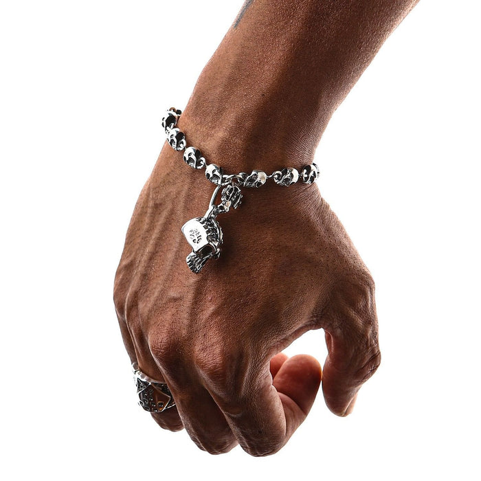 A premium men's gothic skull bracelet with a unique central jeweled charm and a secure toggle clasp.