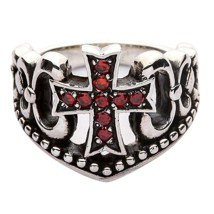 Studio isolation of the oxidized silver ring displaying the red stone cross, scrollwork, and beaded bottom edge.
