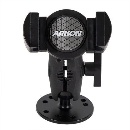 The black RoadVise® XL Holder with a circular drill-base mount features adjustable arms for secure phone mounting on flat surfaces. The Arkon logo appears on the front.