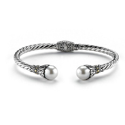Samuel B. Sterling Silver and 18K Yellow Gold Cable Style Fresh Water Bangle. Our Sterling Silver 18k solid Gold 3mm twisted cable bangle with pearl endcaps, handcrafted in Bali by our skilled artisans. The Gems of the Sea collection is inspired by the beauty of the white beaches, sparkling sea and the flourishing coral reefs of Bali.