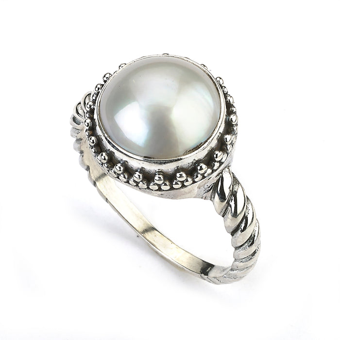 Samuel B. Sterling Silver and White Mabe Pearl Batur Ring with cable style shank, Size 7.5. Our Sterling Silver white mabe pearl ring with twisted shank, handcrafted in Bali by our skilled artisans. The Gems of the Sea collection is inspired by the beauty of the white beaches, sparkling sea and the flourishing coral reefs of Bali.