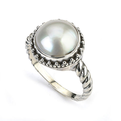 Samuel B. Sterling Silver and White Mabe Pearl Batur Ring with cable style shank, Size 7.5. Our Sterling Silver white mabe pearl ring with twisted shank, handcrafted in Bali by our skilled artisans. The Gems of the Sea collection is inspired by the beauty of the white beaches, sparkling sea and the flourishing coral reefs of Bali.