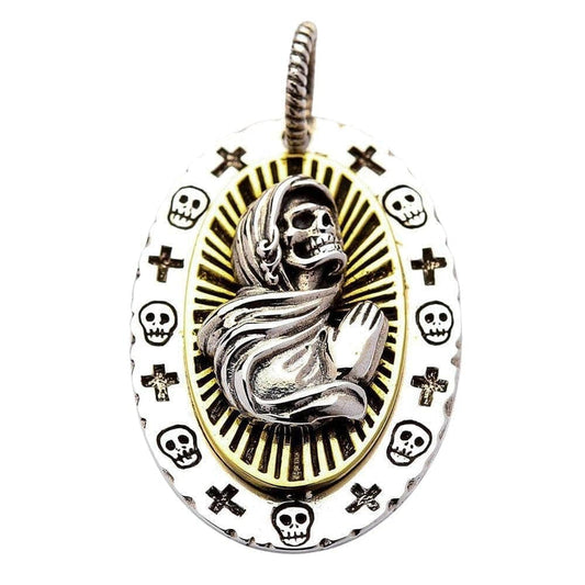 A unique two-tone religious pendant with a praying skull figure of Santa Muerte, set against a golden halo.