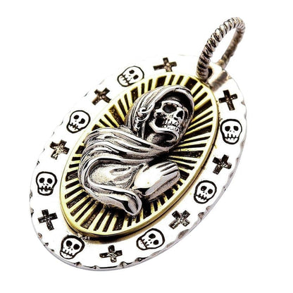 A detailed pendant of the praying skeleton Santa Muerte, a unique piece of Mexican folk art jewelry.