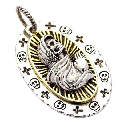 A direct front view of the Holy Death pendant, showing the intricate details of the praying skeleton and the radiant halo.