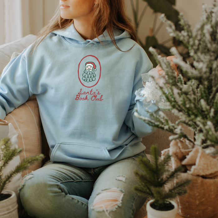 Santa's Book Club Hoodie - The Bean Workshop - Bookaholic, Bookish Apparel, Bookworm Hoodie, Christmas Hoodie for Book Lovers, Cozy Reader Gift, Festive Loungewear, Gift for Readers, Hand-Drawn, Holiday Pullover, Minimalist Christmas, Santa's Book Club Hoodie, Whimsical Santa, Winter Wear