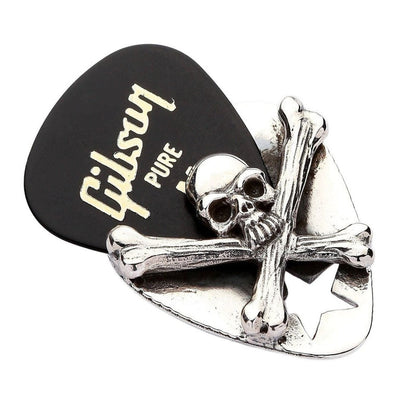 Close-up of skull crossbones pendant holding black Gibson Pure guitar pick showing secure grip design