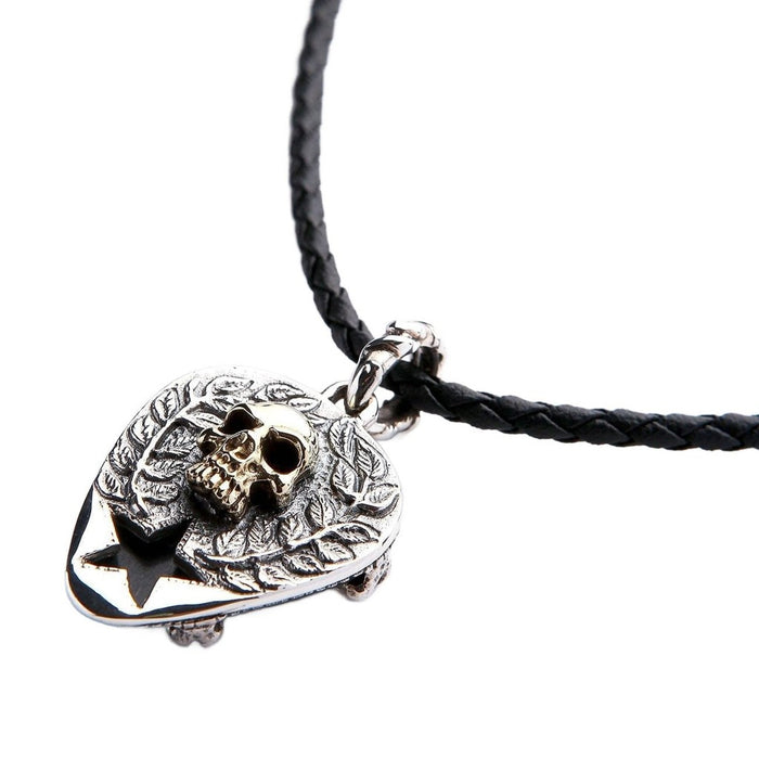 Reversible skull pendant on leather cord showing gothic thorned skull with gold accent and star