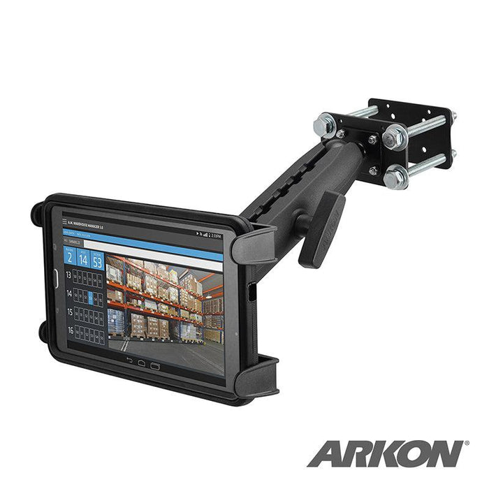 The Slim-Grip® Tablet Holder with Forklift Front Guard Mount and 10.25 Metal Arm securely holds a tablet displaying warehouse inventory. The sturdy adjustable arm attaches to metal surfaces, ideal for busy workspaces. Arkon logo shown bottom right.