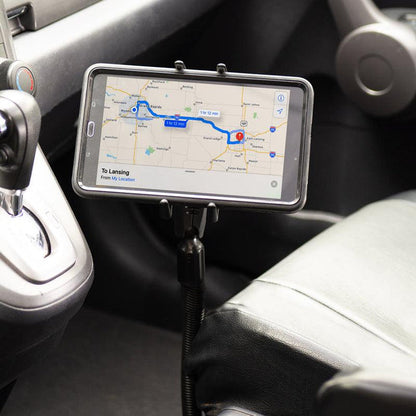 A Slim-Grip® Ultra Phone or Midsize Tablet Seat Rail Mount holds a smartphone by the driver’s seat, displaying navigation directions for convenient and safe in-car use.