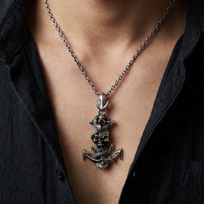 Man wearing snake anchor skull sterling silver pendant on silver chain with dark shirt