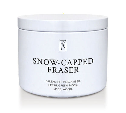 White tin container of 'Snow-Capped Fraser' candle with a logo on a white background