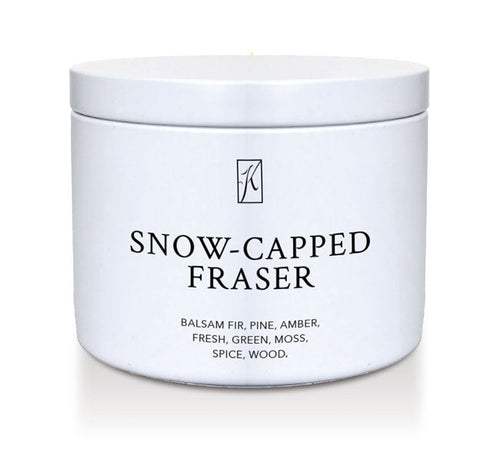 White tin container of 'Snow-Capped Fraser' candle with a logo on a white background