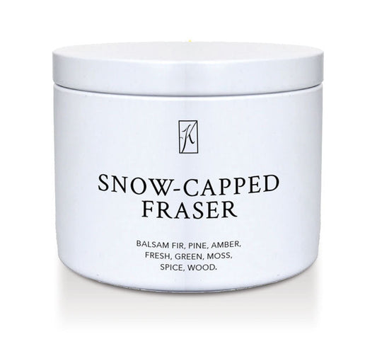 White tin container of 'Snow-Capped Fraser' candle with a logo on a white background