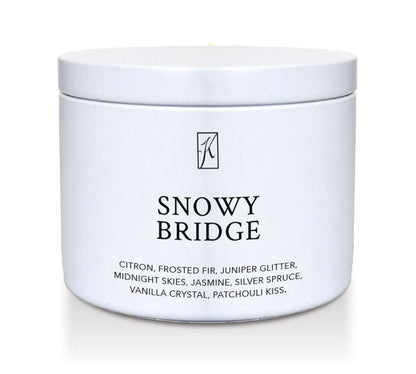 White candle tin labeled 'Snowy Bridge' with a brand logo on a white background