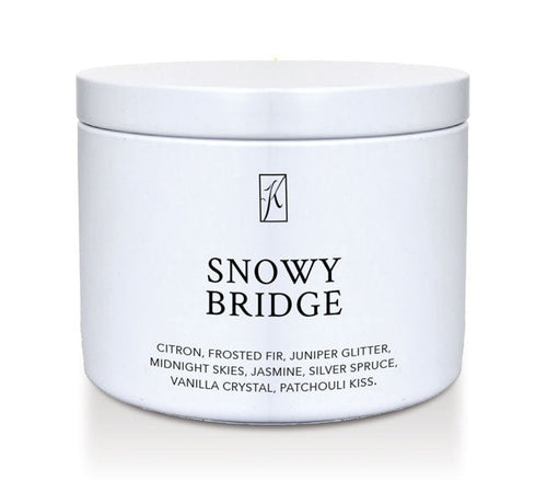 White candle tin labeled 'Snowy Bridge' with a brand logo on a white background