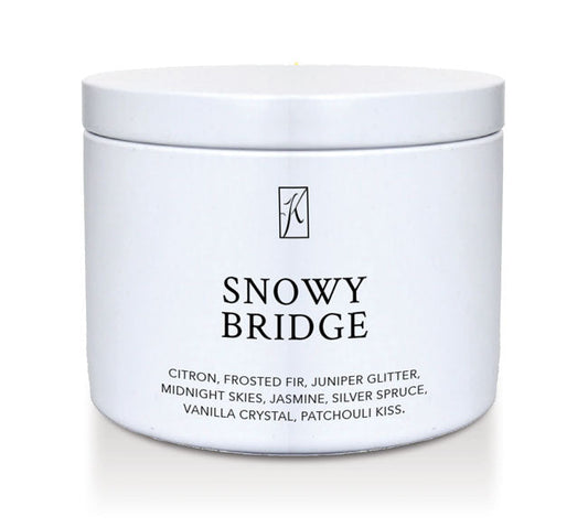 White candle tin labeled 'Snowy Bridge' with a brand logo on a white background