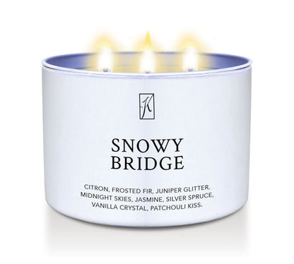 Candle in a white tin labeled 'Snowy Bridge' with flames on a white background