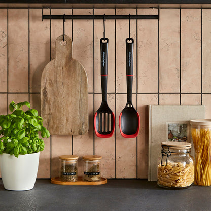 Kitchen utensils and ingredients on a tiled wall