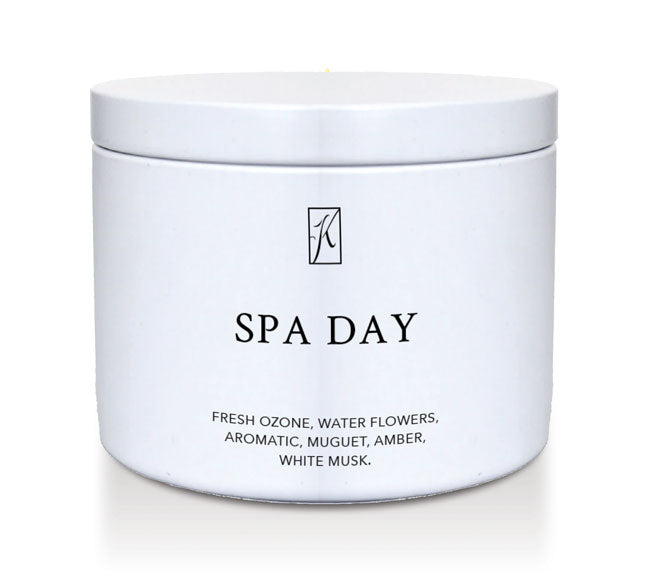 Candle in a white container labeled 'SPA DAY' with a logo on a white background