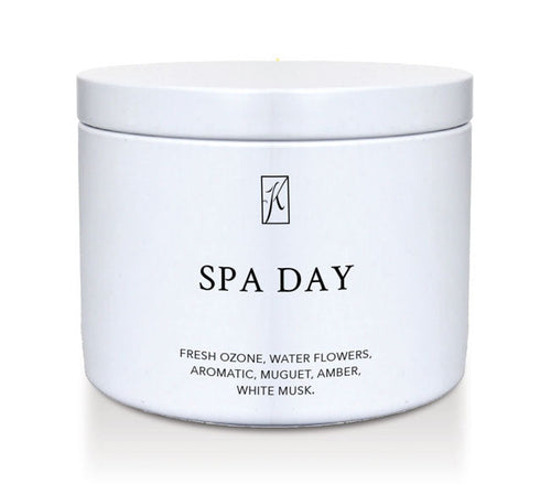 Candle in a white container labeled 'SPA DAY' with a logo on a white background