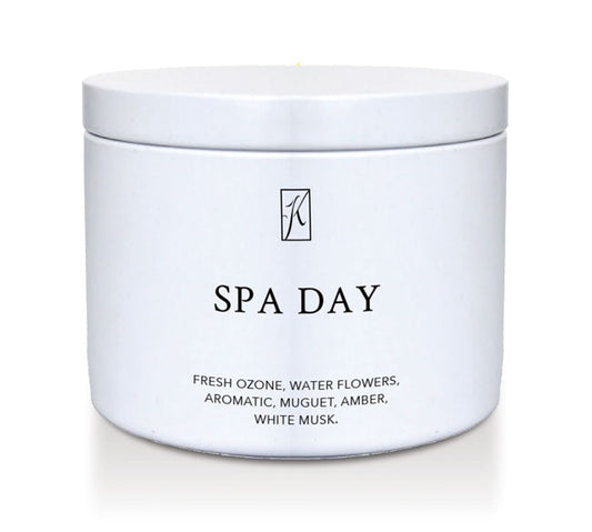 Candle in a white container labeled 'SPA DAY' with a logo on a white background