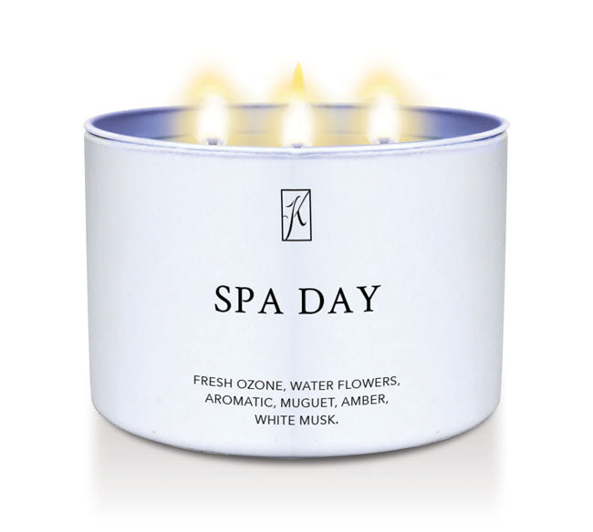 Candle in a white container labeled 'SPA DAY' with a logo on a white background