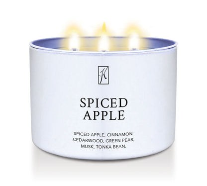 Candle in a white container labeled 'Spiced Apple' with flames on a white background