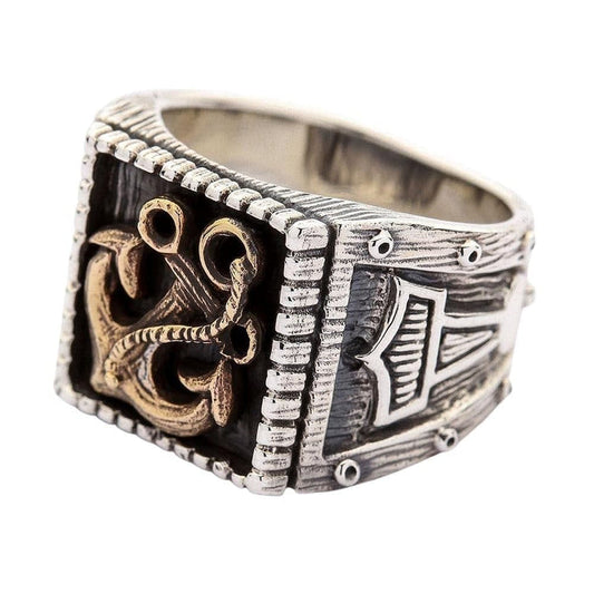 A premium two-tone sterling silver and brass anchor viking ring with ornate Thor's Hammer side engravings.