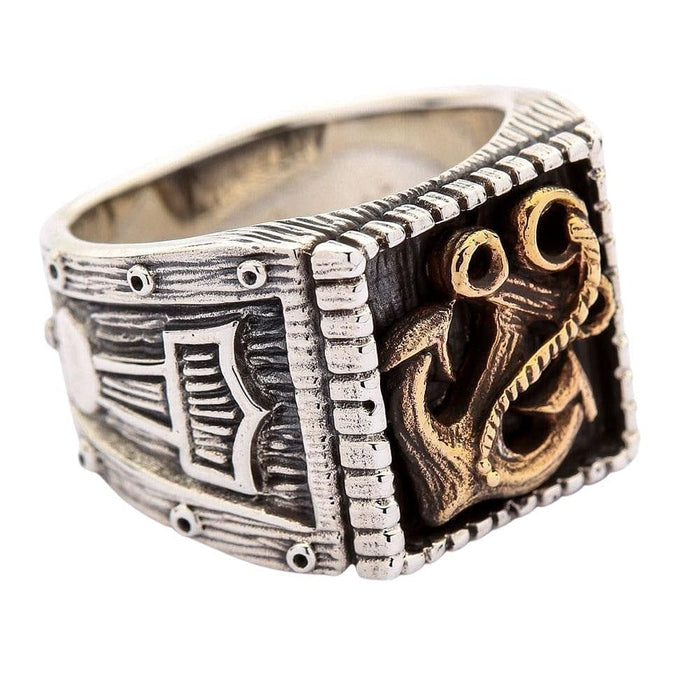 A unique Norse mariner ring featuring a bold brass anchor and a detailed Thor's Hammer (Mjolnir) emblem on the side.