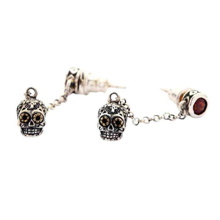 A premium pair of Mexican sugar skull earrings with fiery red gem studs, a beautiful piece of wearable folk art jewelry.