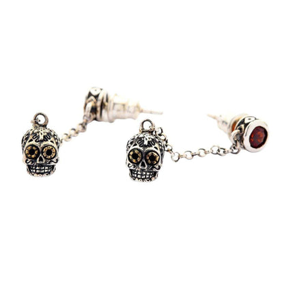 A premium pair of Mexican sugar skull earrings with fiery red gem studs, a beautiful piece of wearable folk art jewelry.