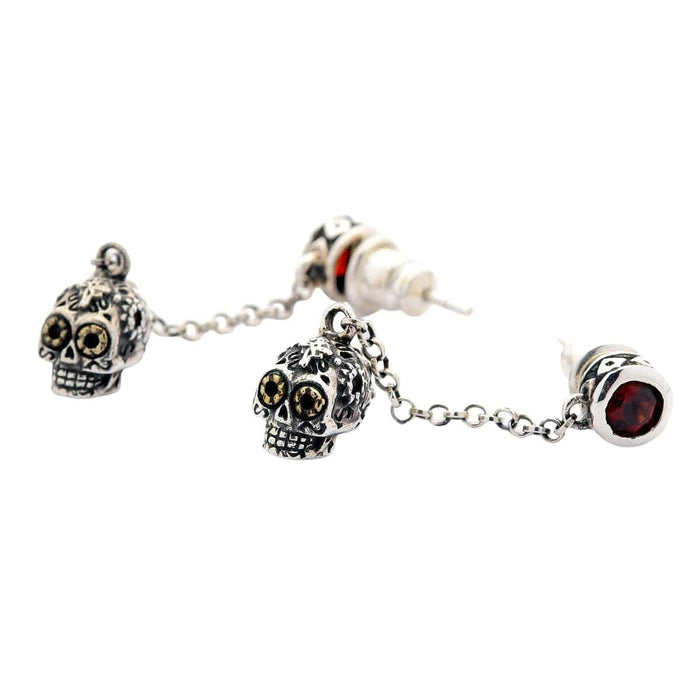 A pair of unique gothic-style dangle skull earrings with intricate details and a creative two-part design.