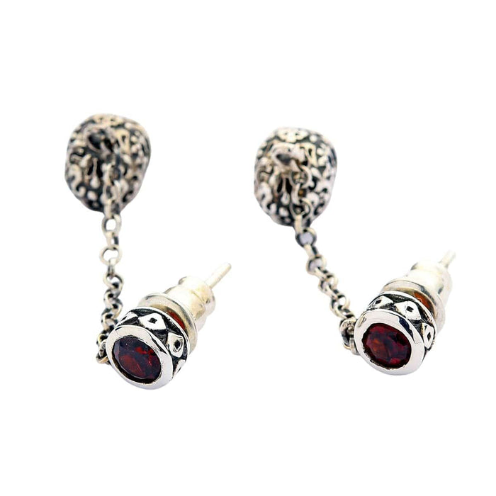 A pair of masterfully handcrafted Calavera earrings with detailed engravings and a unique, elegant drop design.