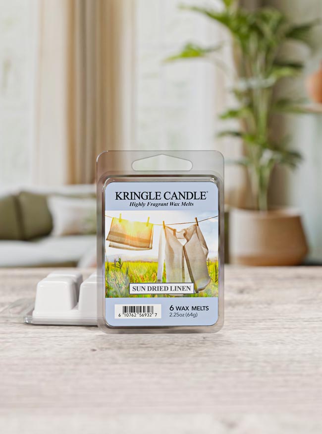 Kringle Candle wax melt package on a table with a blurred indoor background