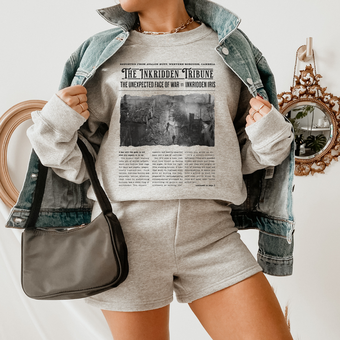 The Inkridden Tribune The Unexpected Face of War Sweatshirt - The Bean Workshop - Bookish Clothing, Bookworm Apparel, Cozy Reader Gift, Dark Academia sweatshirt, Divine Rivals, Divine Rivals sweatshirt, Fantasy Book Merch, Inkridden Tribune apparel for readers, Iris Winnow, Letters of Enchantment, Letters of Enchantment merch, Literary Quote, Rebecca Ross, Rebecca Ross cozy sweater, Roman Kitt, sweatshirt, Vintage Newspaper