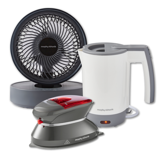 A set of three portable travel appliances including a black and white electric kettle, a grey and red portable steam iron, and a black oscillating USB fan.