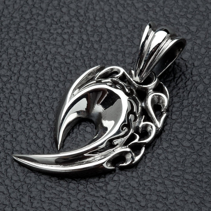 An angled view of the gothic claw pendant, highlighting its polished finish and openwork flames.