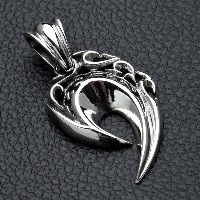 A side profile of the men's tribal flame pendant, showing its sharp, curved shape.