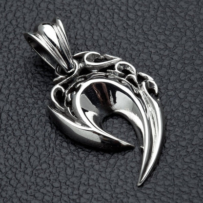 A side profile of the men's tribal flame pendant, showing its sharp, curved shape.