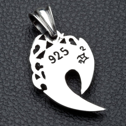 The back of the silver fang pendant, showing the .925 hallmark stamp and openwork design.